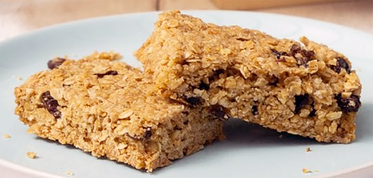 two oat and raisin flapjacks on a light blue plate