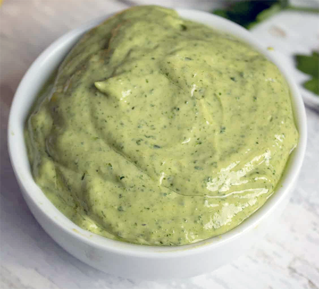 Prince of Wales' sauce, a green egg and herb sauce mounded in a small white bowl