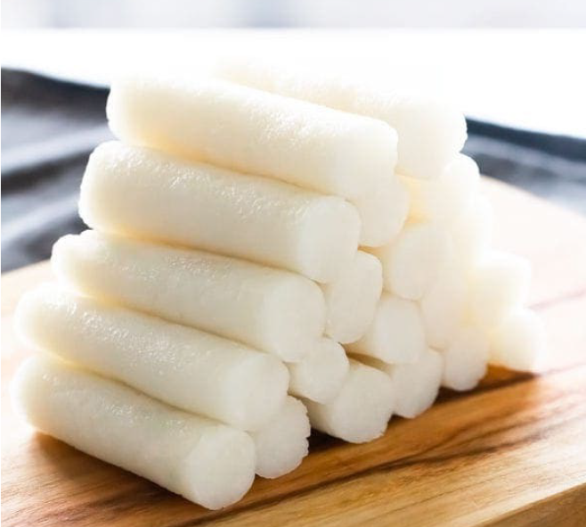 garaetteok, Korean cylinder rice cakes piled as a pyramid on a chopping block