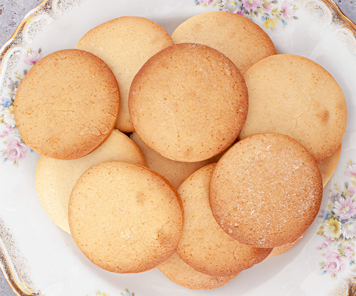 pile of honey snap biscuits presented on a plate