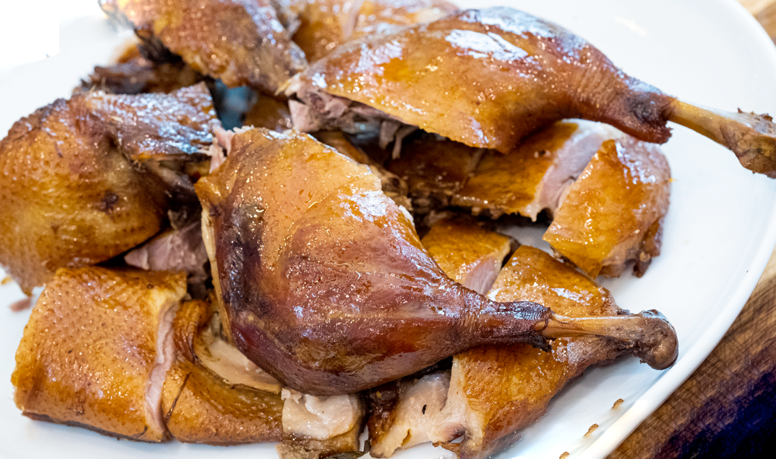 hunan braised duck pieces arranged on a white plate