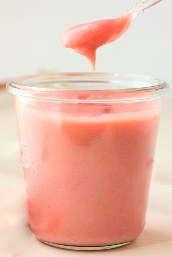 pink japanese knotweed curd being spooned from a jar