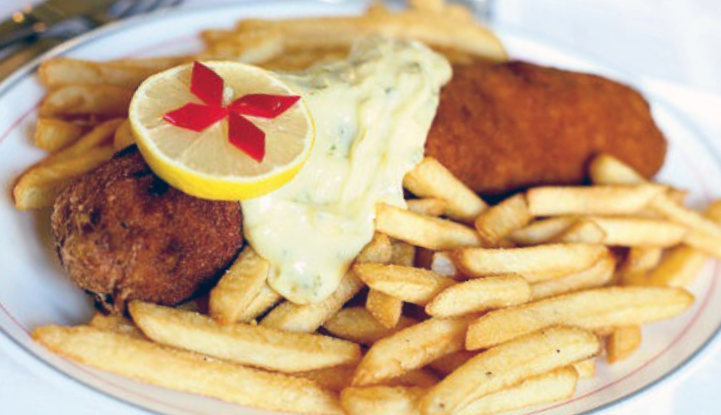 Breaded kardordeva steak served on a plate with chips (fries)