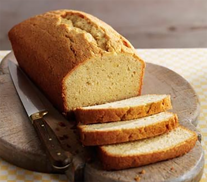 Madeira loaf cake sliced on a wooden board