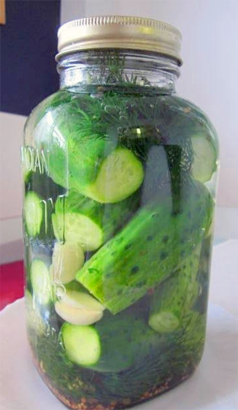 Russian salted pickled gherkins in a lidded glass jar