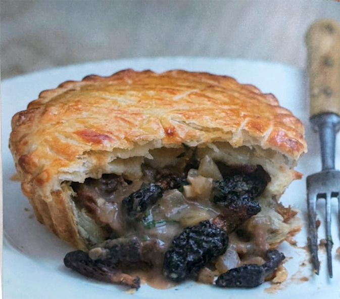 morel pie with a fork with almost half the pie removed to reveal the morel filling
