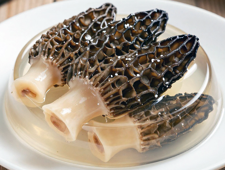 whole morel mushrooms in clear aspic jelly presented on a plate