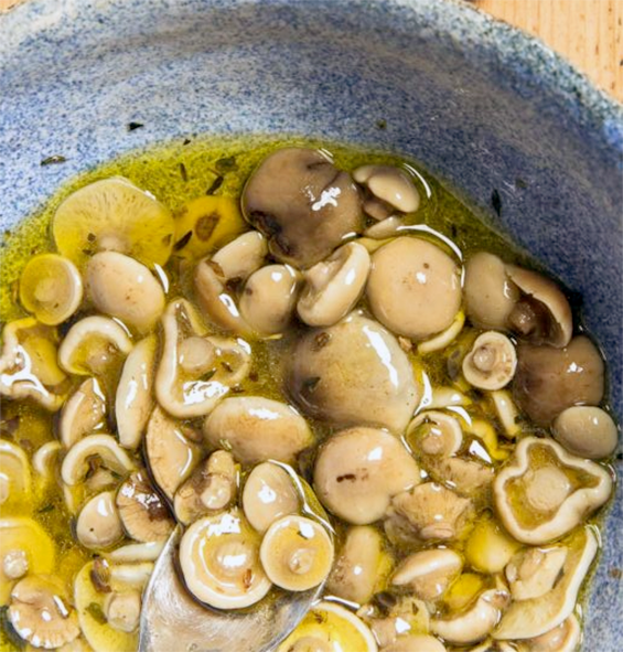 pickled honey fungus in a speckled blue bowl