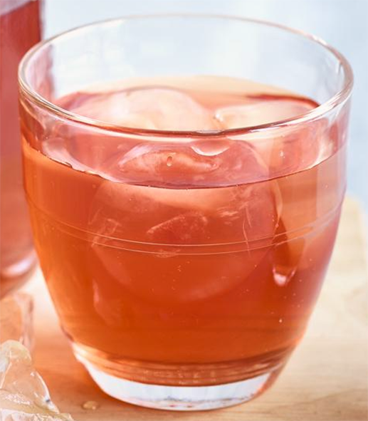 Pineapple kombucha served in a glass over ice