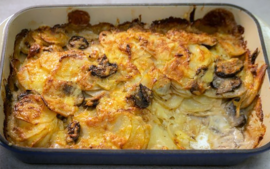 potato and mixed wild mushrooms in a cheesy cream sauce cooked in a baking dish