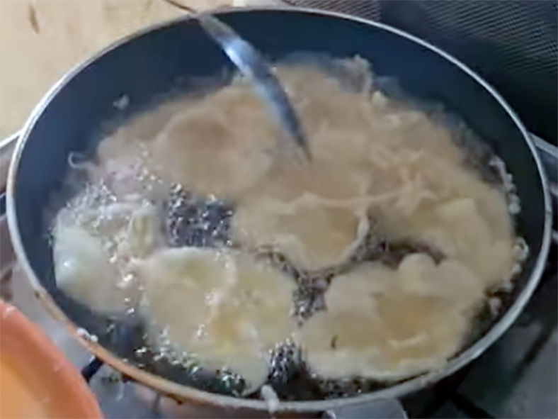 Sierra Leonean pancakes cooking in a frying pan