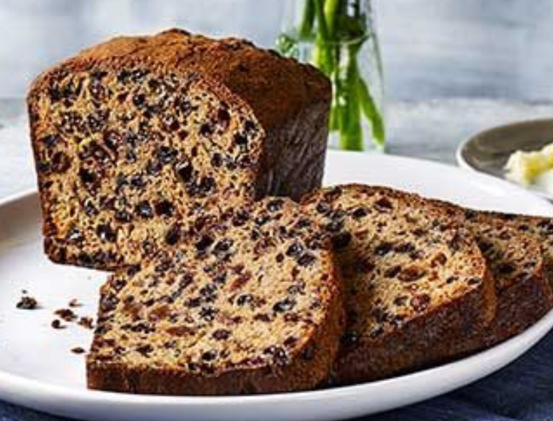 tea loaf with slices in front of the main loaf cate presented on a plate