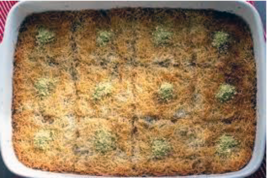 Tel kadayif Turkish dessert in a baking dish cut into twelve squares