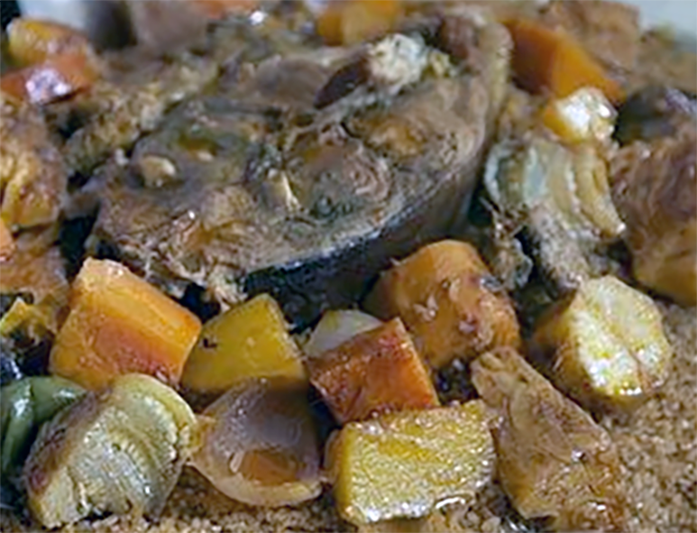 nile perch steak surrounded by mixed vegetbles served on a bed of rice