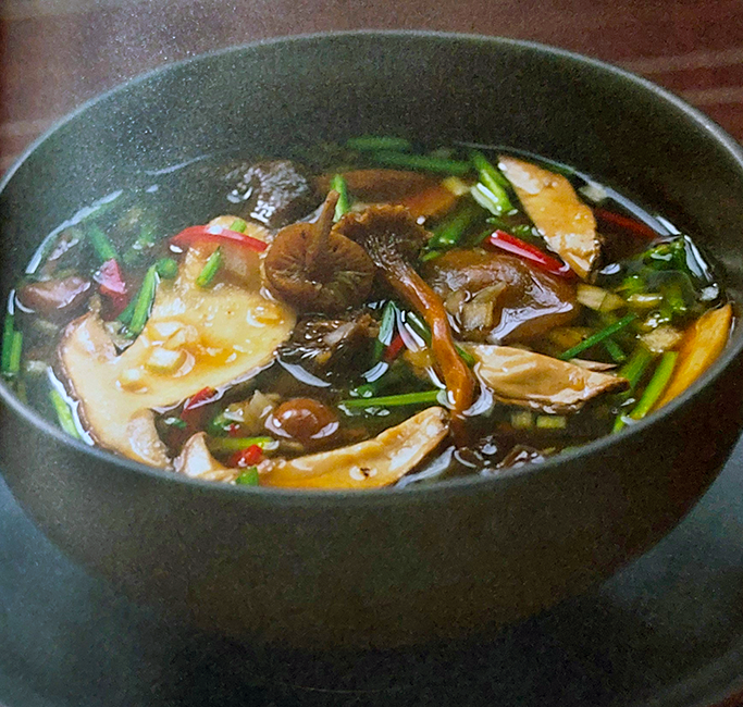 Soup of wild mushrooms and coriander in a miso base served in a bowl