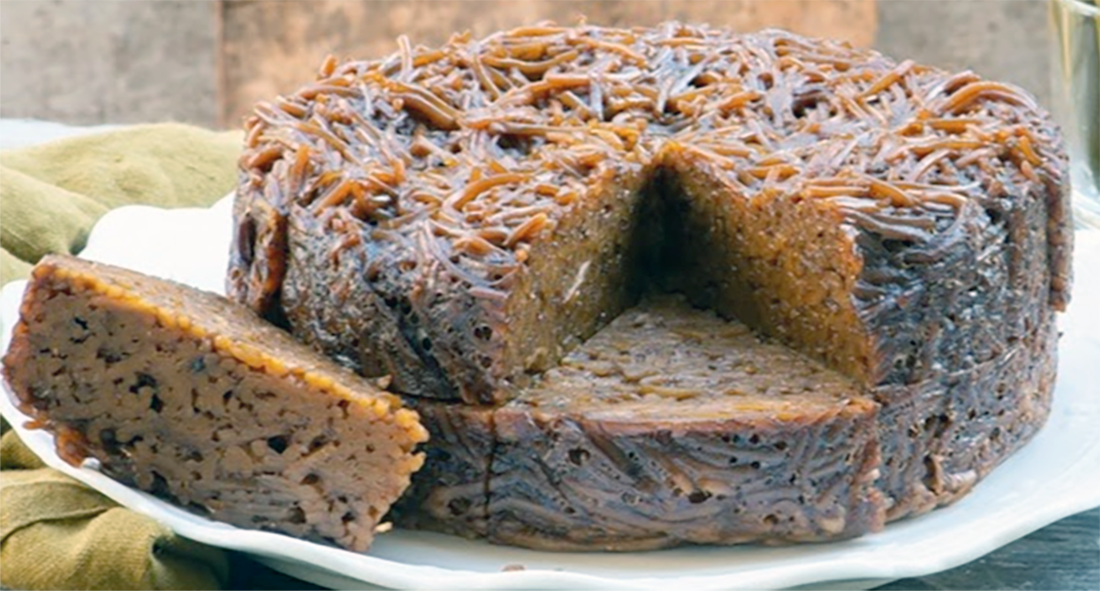 Jerusalem kugel cake on a white plate with half a slice removed and set on the side
