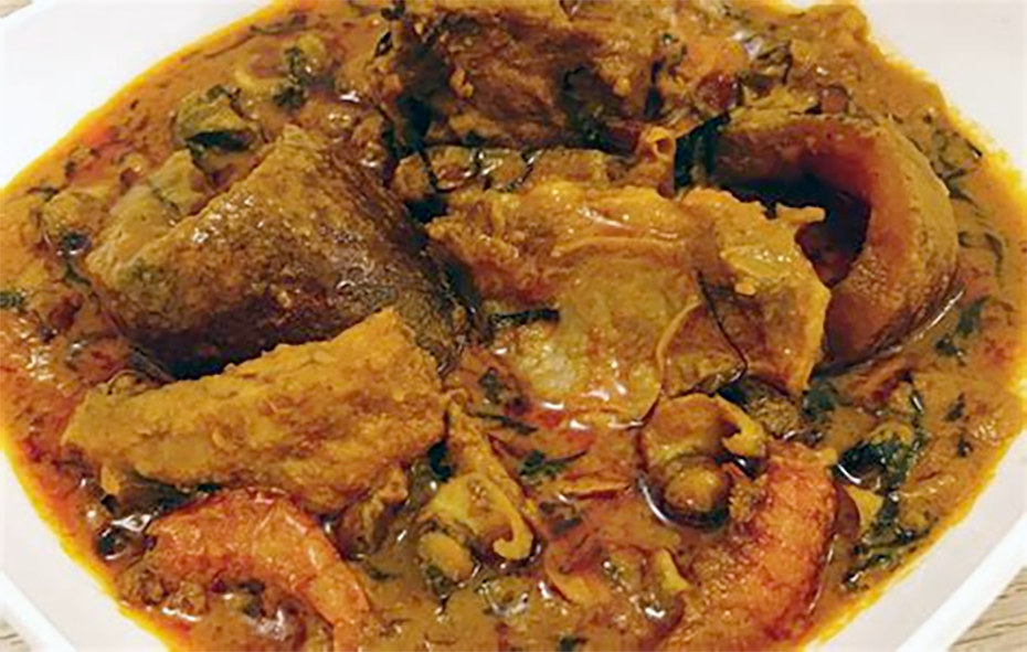 stew of meat, fish and atama leaves cooked in palm nut juice and served in a bowl