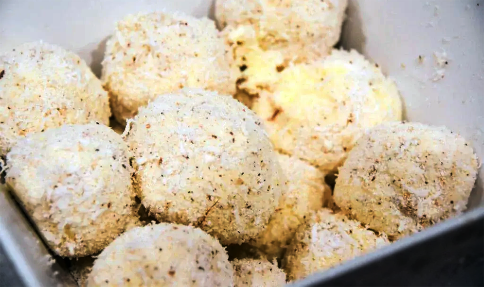 vanilla ice cream rolled in desiccated coconut and served in a bowl