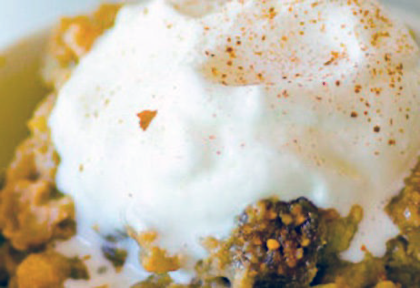 apple barley pudding in a bowl served garnished with cream