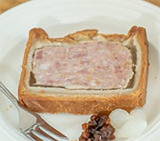 slice of ascot pie on a plate with pickles