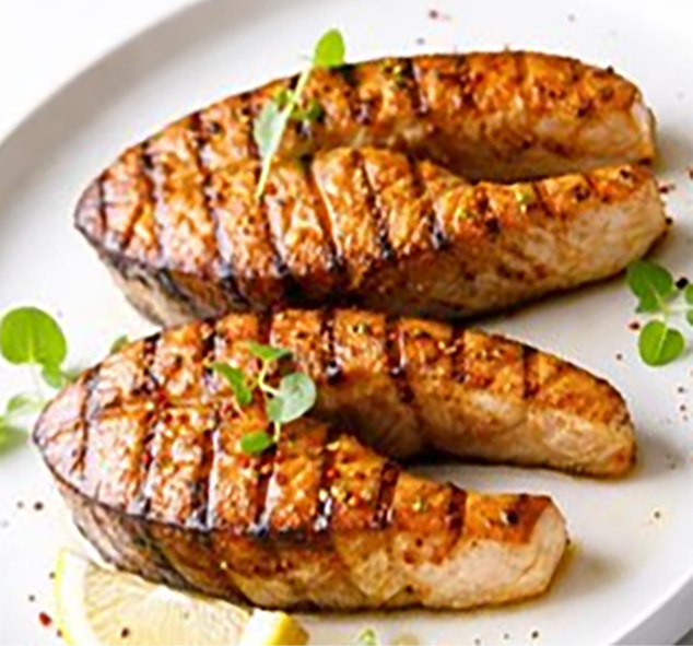 marinated and barbecued fish steaks served on a plate