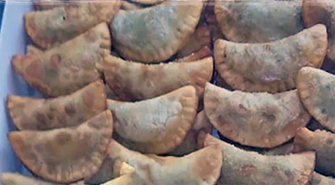 fried turnovers with a sweet potato, almond and lemon filling arranged on a plate