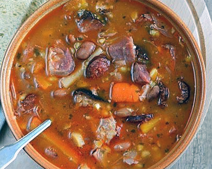 bean soup served topped with sliced sausage
