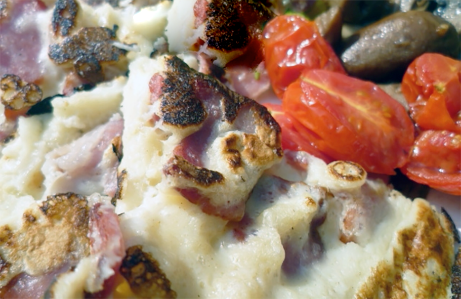 bacon froise served with fried baby plum tomatoes and button mushrooms