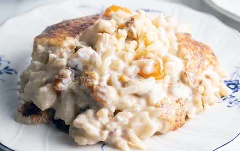 baked rice pudding with chopped peanuts served on a plate
