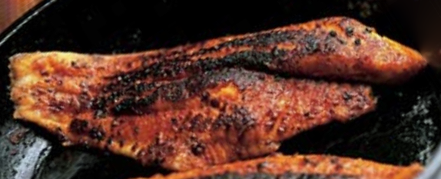 cajun blackened catfish in a cast iron pan