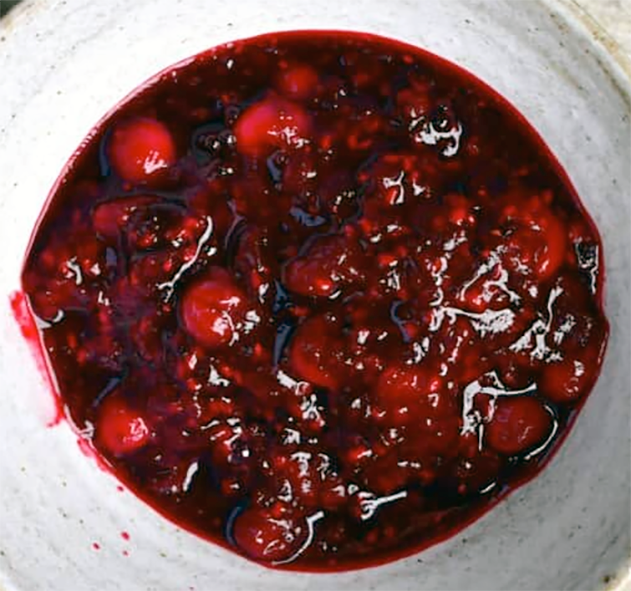 mixed berry compote cooked in Ribena served in a bowl</alt.