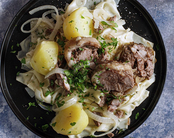 Beshbarmak, Turkmenistan dish of noodles topped with potatoes, meat and finely-chopped herbs
