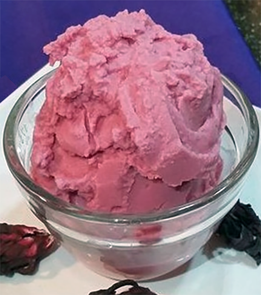 scoop of custard-based hibiscus ice cream in a small glass bowl