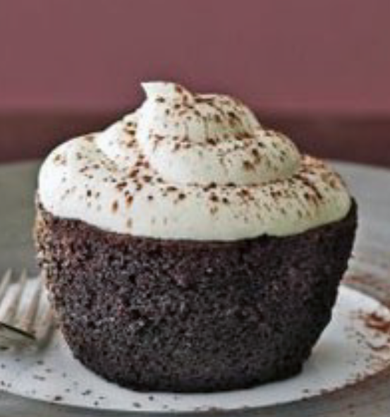 black velvet baby cake pudding topped with a swirl of cream and grated chocolate
