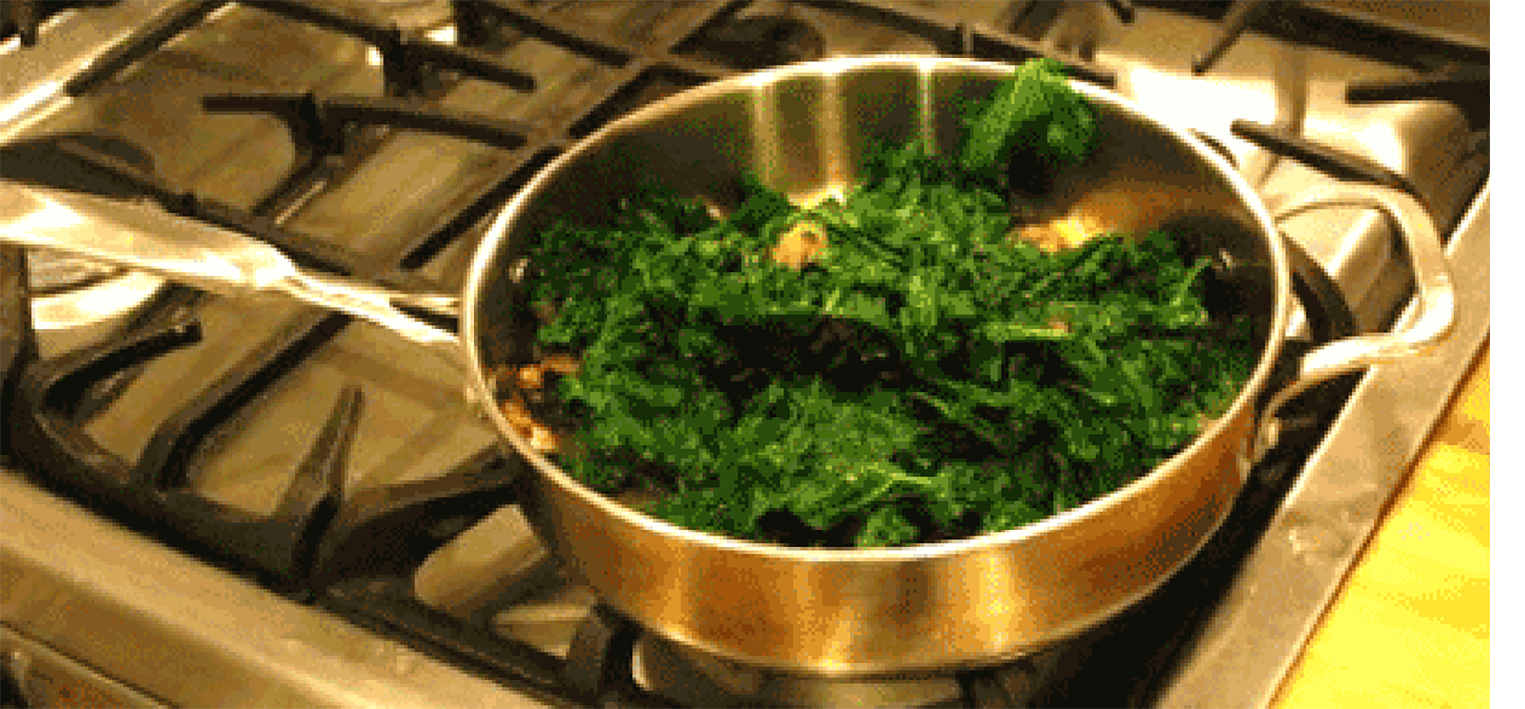 Kale being blanched in a pan of boiling water