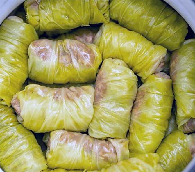 Bosnian sarma, meat stuffed cabbage rolls packed in a baking dish