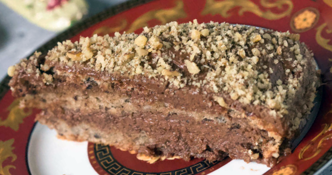 slice of Serbian chocolate walnut cake served on a plate