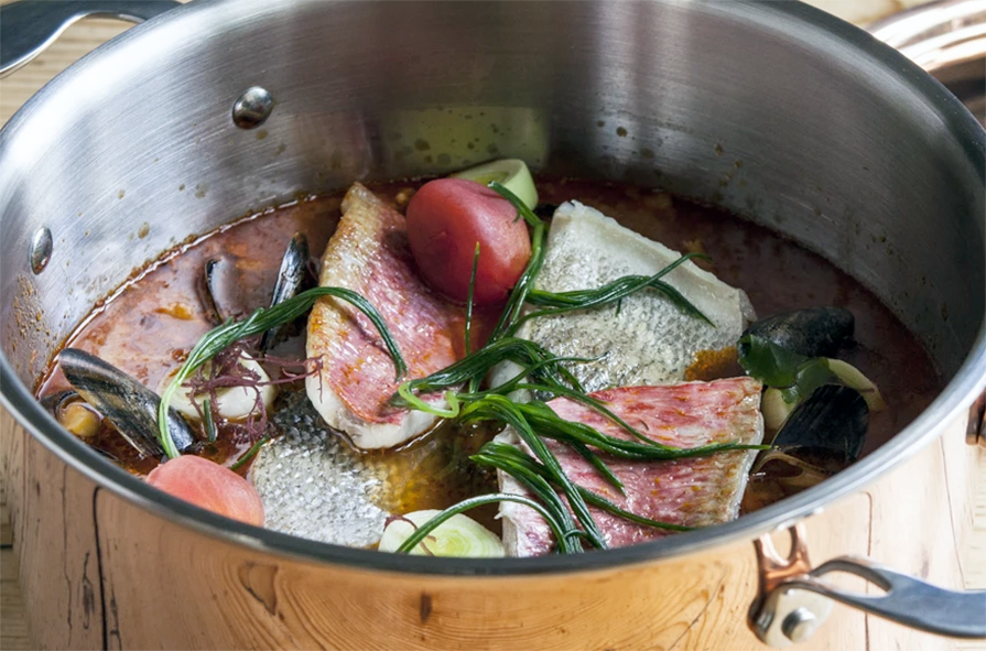 red mullet and sea bass bouillabaisse in a stock pot