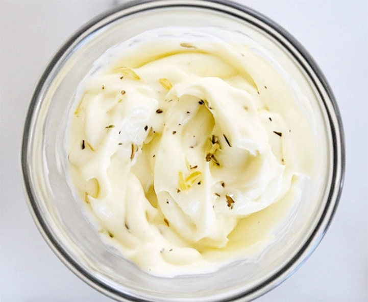 mayonnaise in a glass bowl, garnished with a drizzle of olive oil