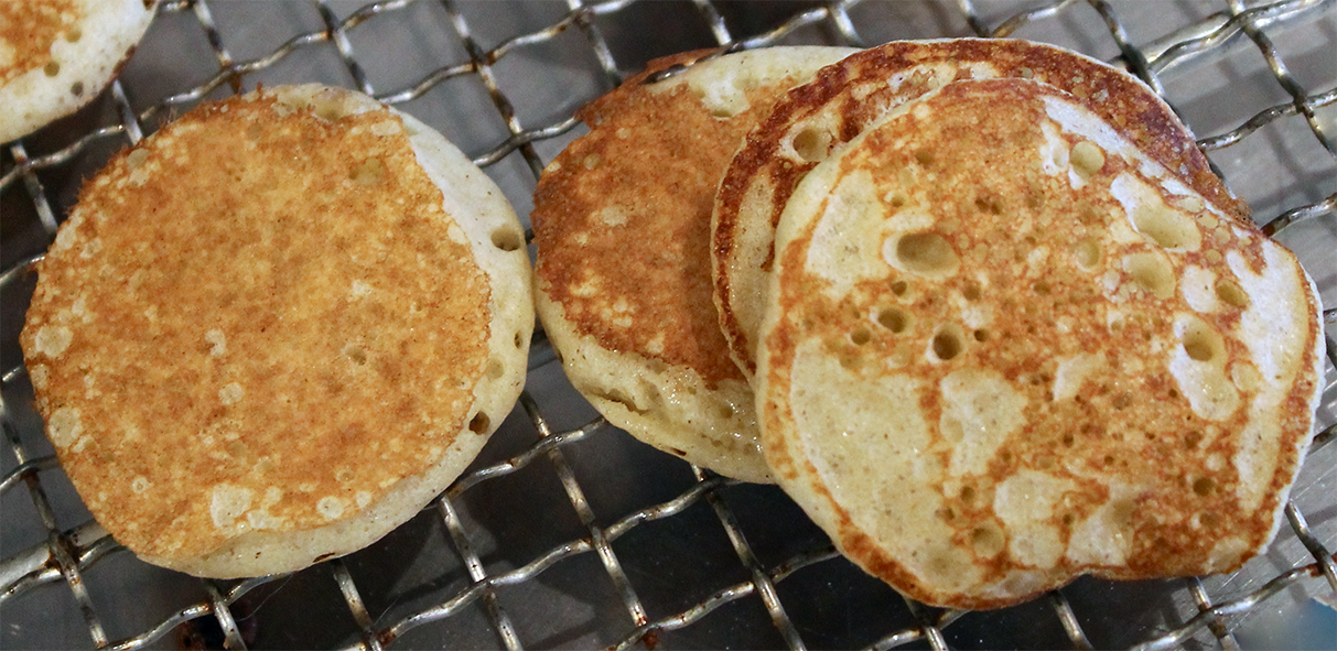 buckwheat blinis arranged on a wire rack