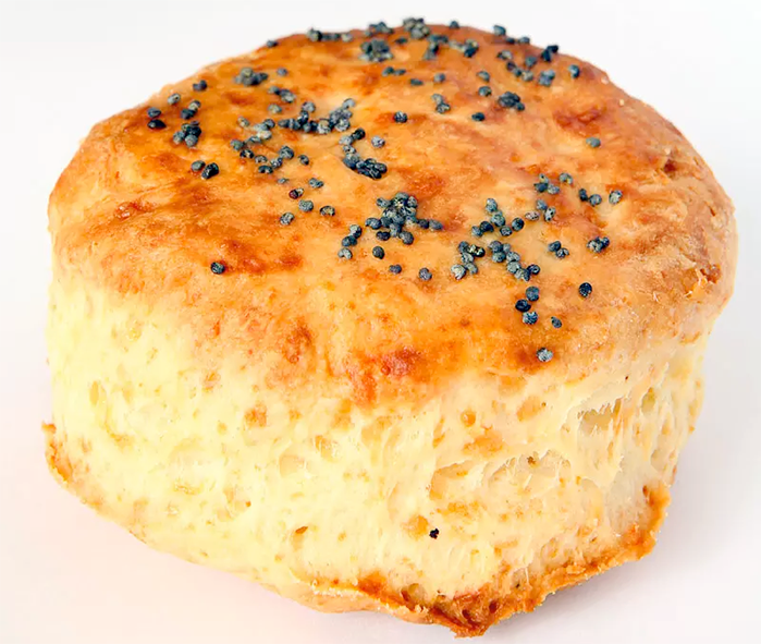 buttermilk mix cheese biscuit with a golden top on an off-white background