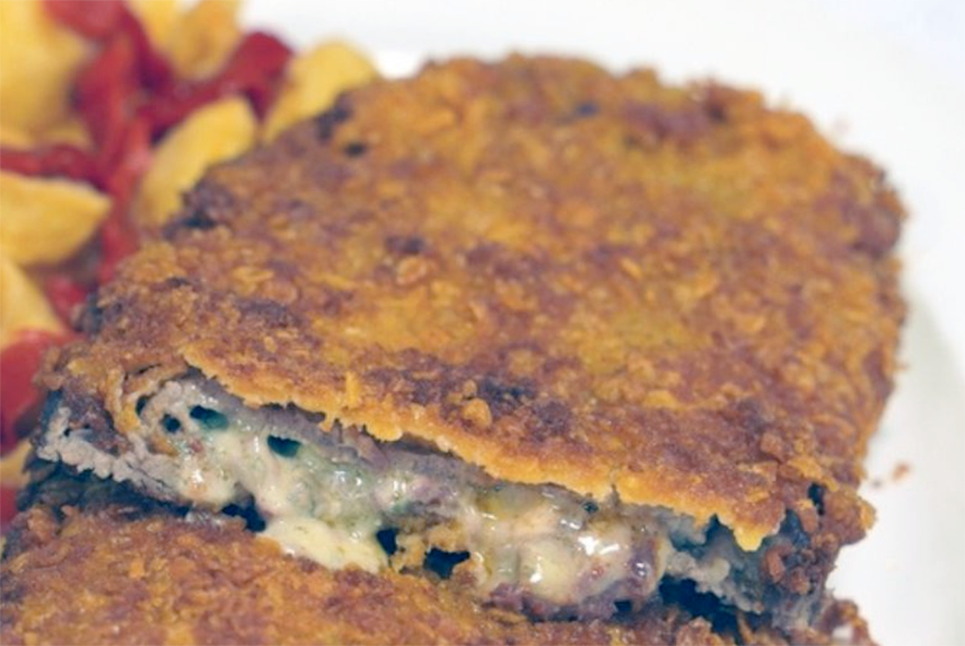 cachopo sliced open to reveal the two layers of beef and the filling inside