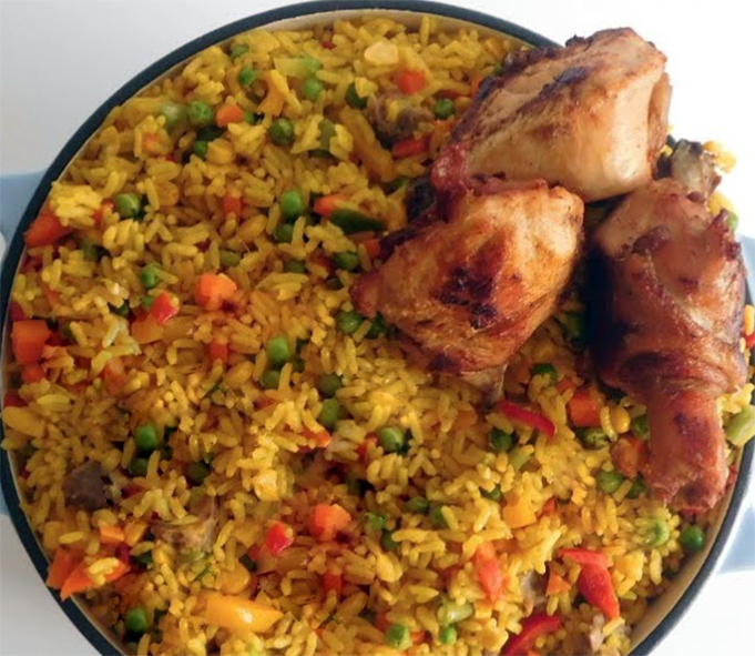 Cameroon fried rice served topped with fried chicken