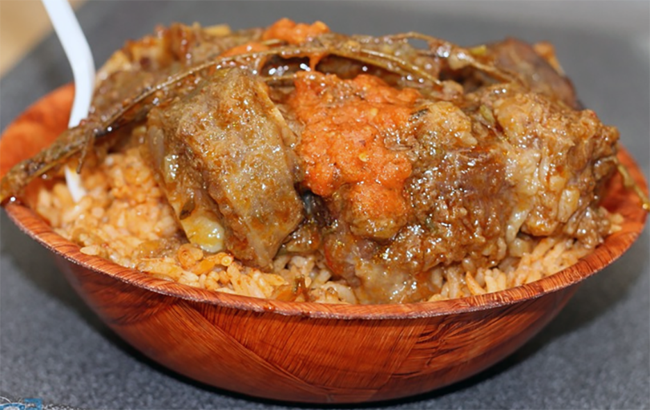 Cameroonian lamb curry served on a bed of rice in a bowl
