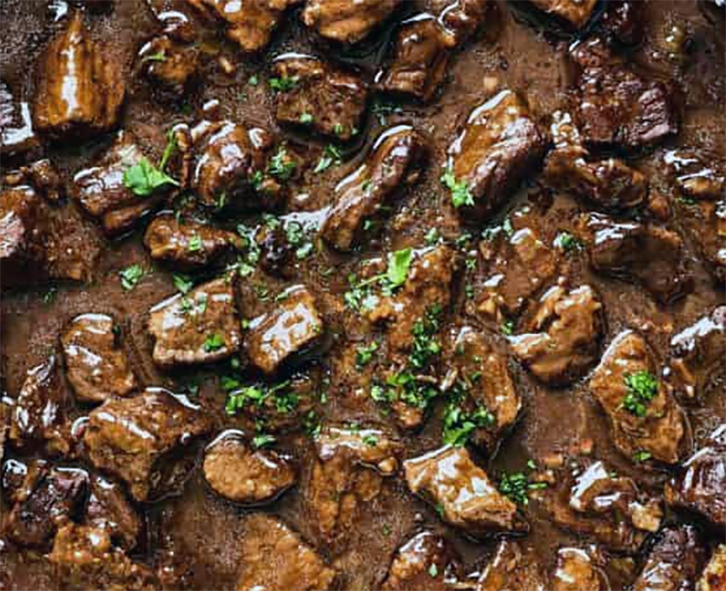 beef stewed in passata and red wine in a casserole dish