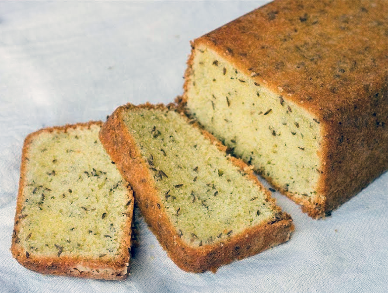 sliced caraway seed loaf cake on a white table cloth