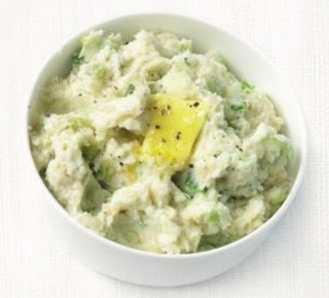 celeriac champ in a bowl garnished with a pat of butter and freshly-ground black pepper