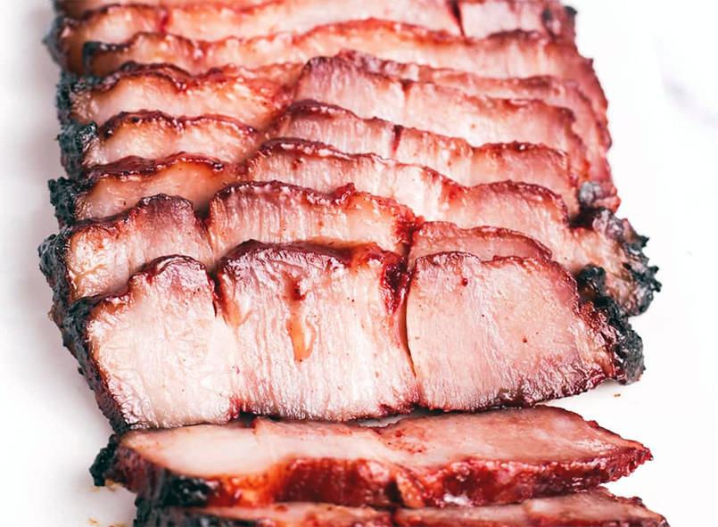 sliced char siu pork arranged on a plate