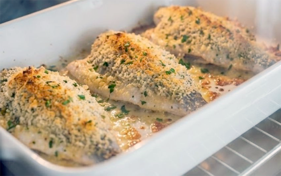 whole sea bream without the head baked with a cheese topping in a baking dish