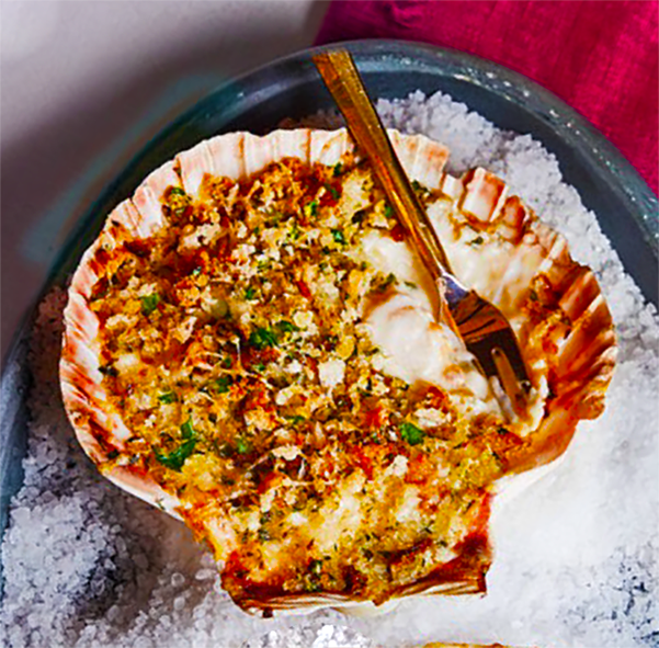 cheesy scallop gratin served in a scallop shell
